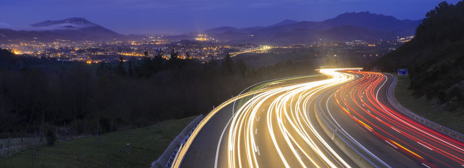 car lights at night on the road going to the city