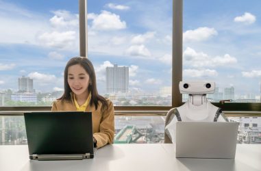 Working women and Robot computers in the office business RPA Robotic Process Automation